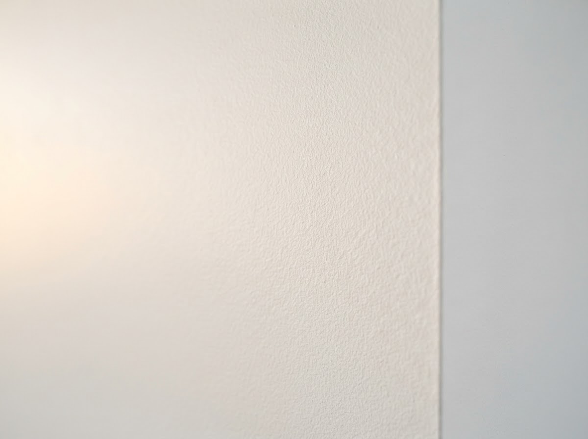 Smooth sanded drywall with subtle orange peel texture