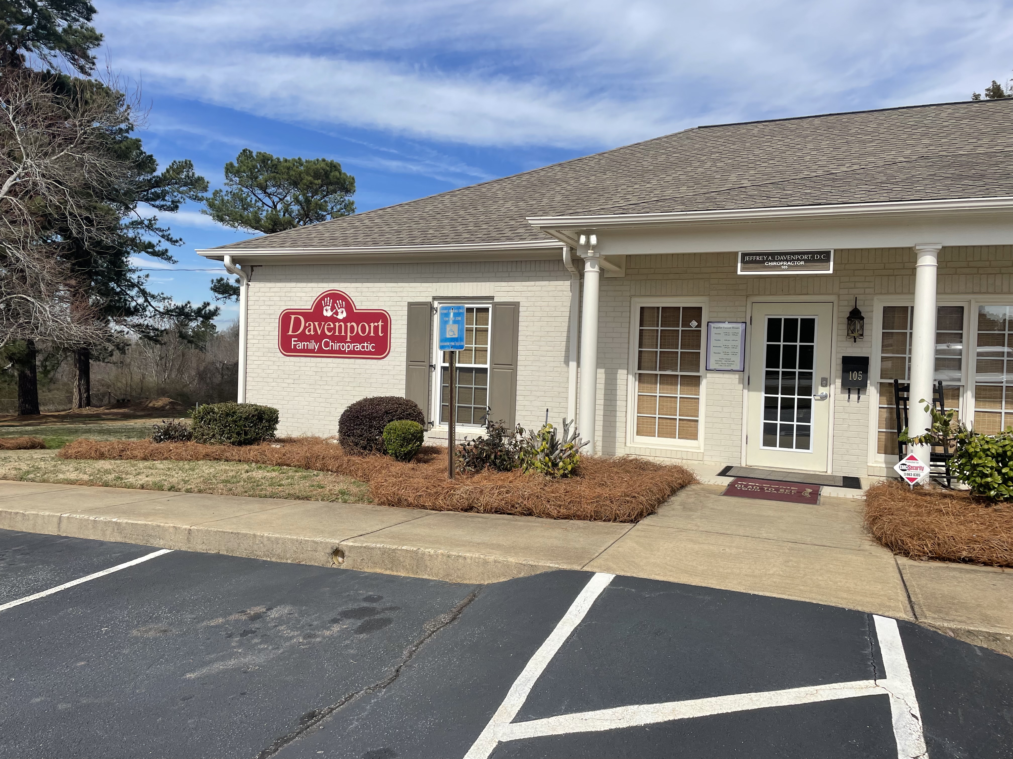 Fresh pine straw installed in landscape beds outside a commercial office in Bogart.