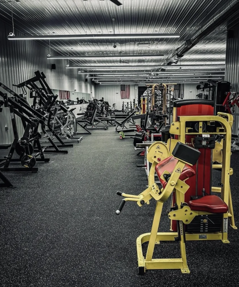 Main gym floor with plate-loaded machines at Iron Body Strength Dingmans Ferry PA