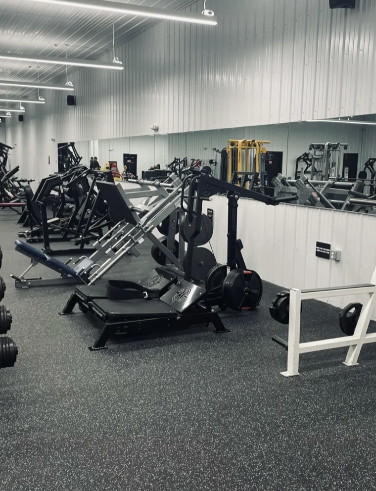 Belt squat and lower body plate-loaded machines at Iron Body gym