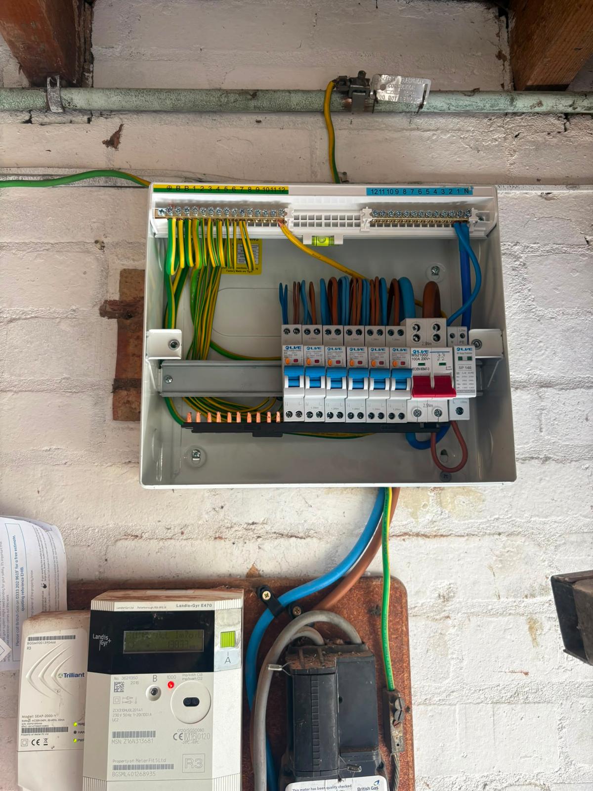 New metal consumer unit with open cover showing neat wiring, RCBOs and surge protector