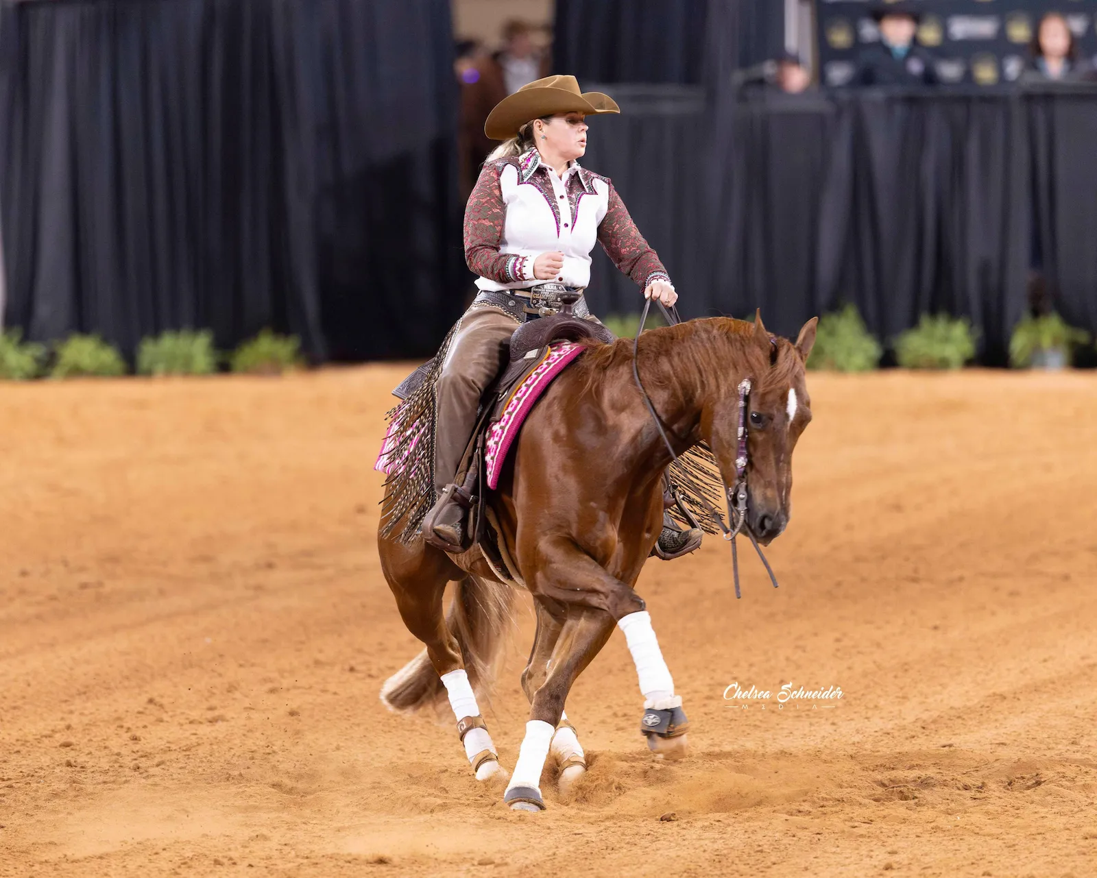 Allison Yeager riding a chestnut reining horse