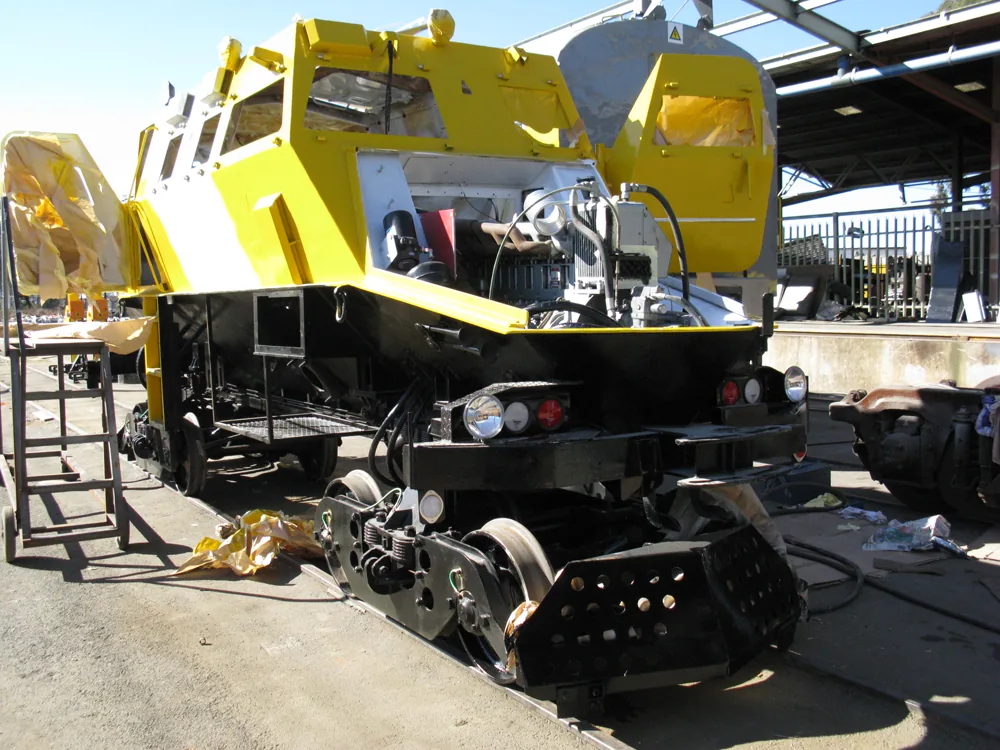 Yellow specialist rail vehicle during assembly