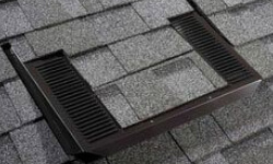 Authentic O'Hagin patented low-profile attic vent installed flush with composition roofing material