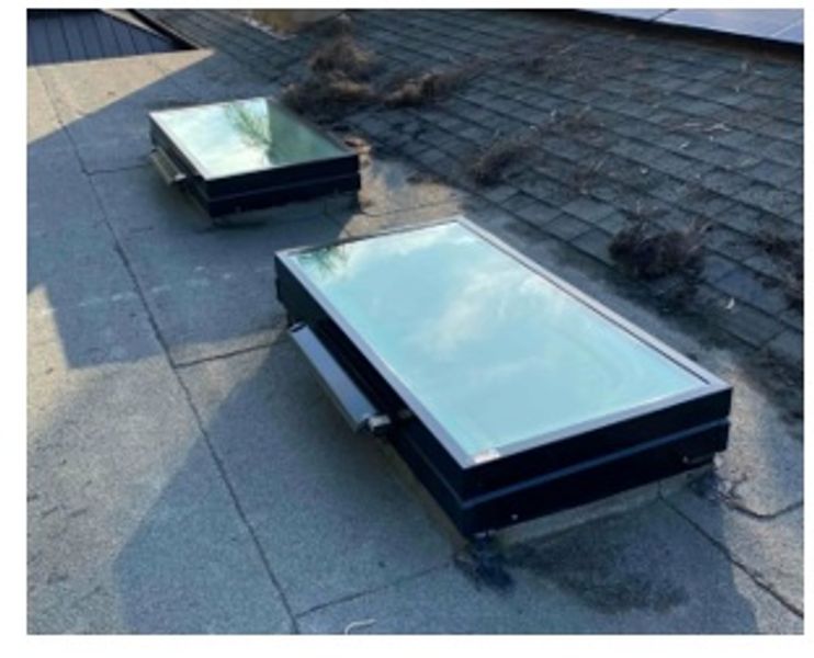 After: a modern operable skylight installed on the same roof