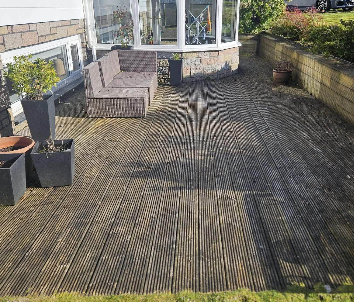 Weathered timber decking before renovation