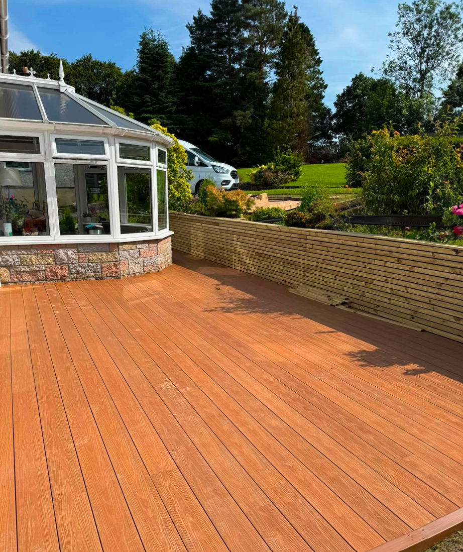 Transformed terrace with composite decking and bespoke privacy screening by SJ Joinery & Building