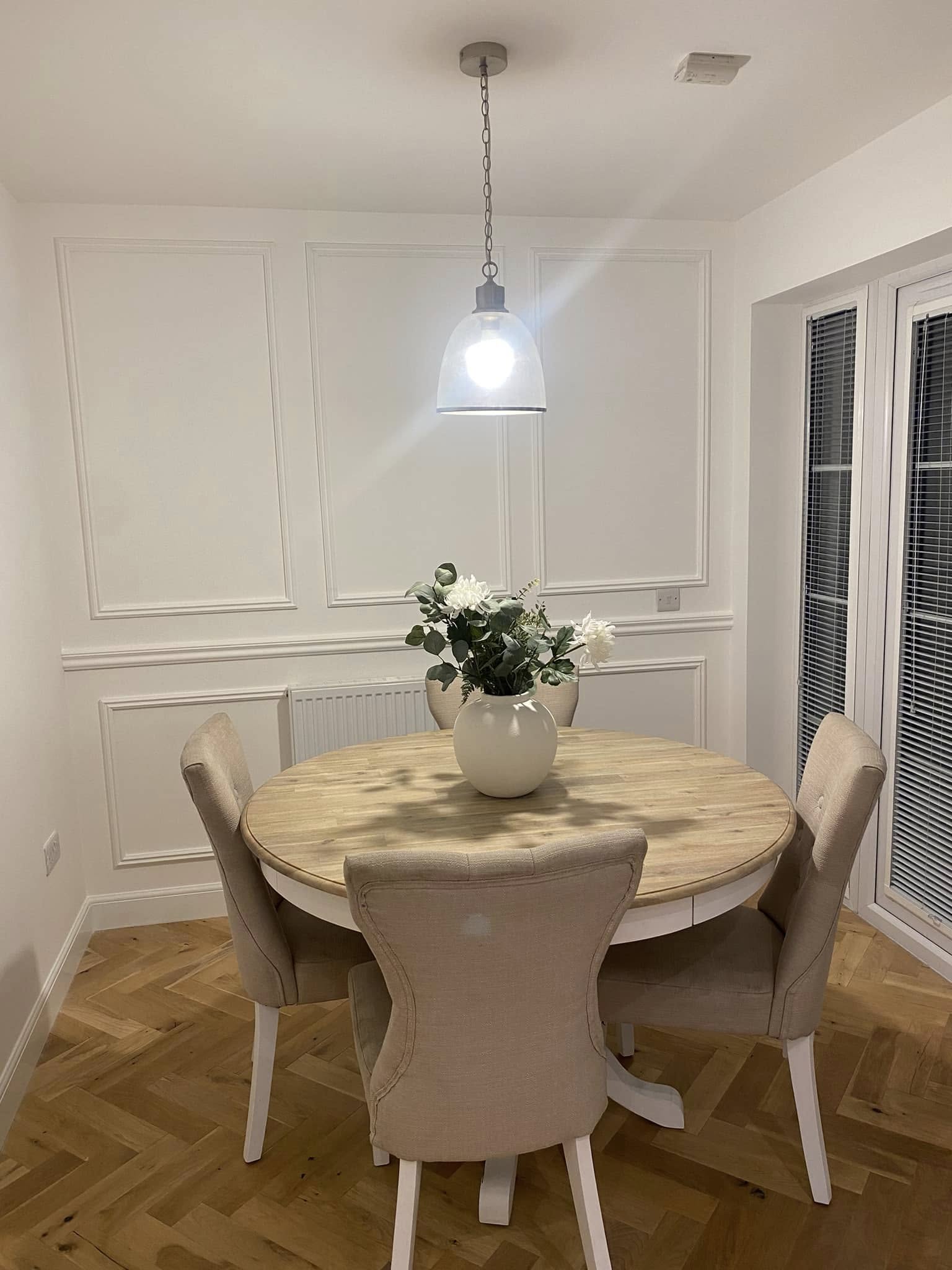 Traditional picture frame wall panelling and wainscoting in a dining room by SJ Joinery & Building