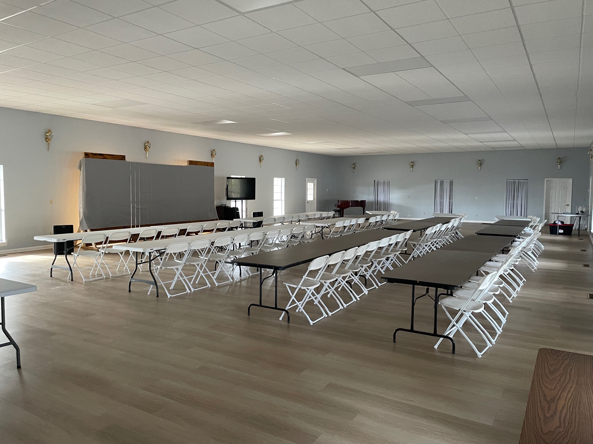 Meeting and retreat table layout with presentation stage in the Event Hall