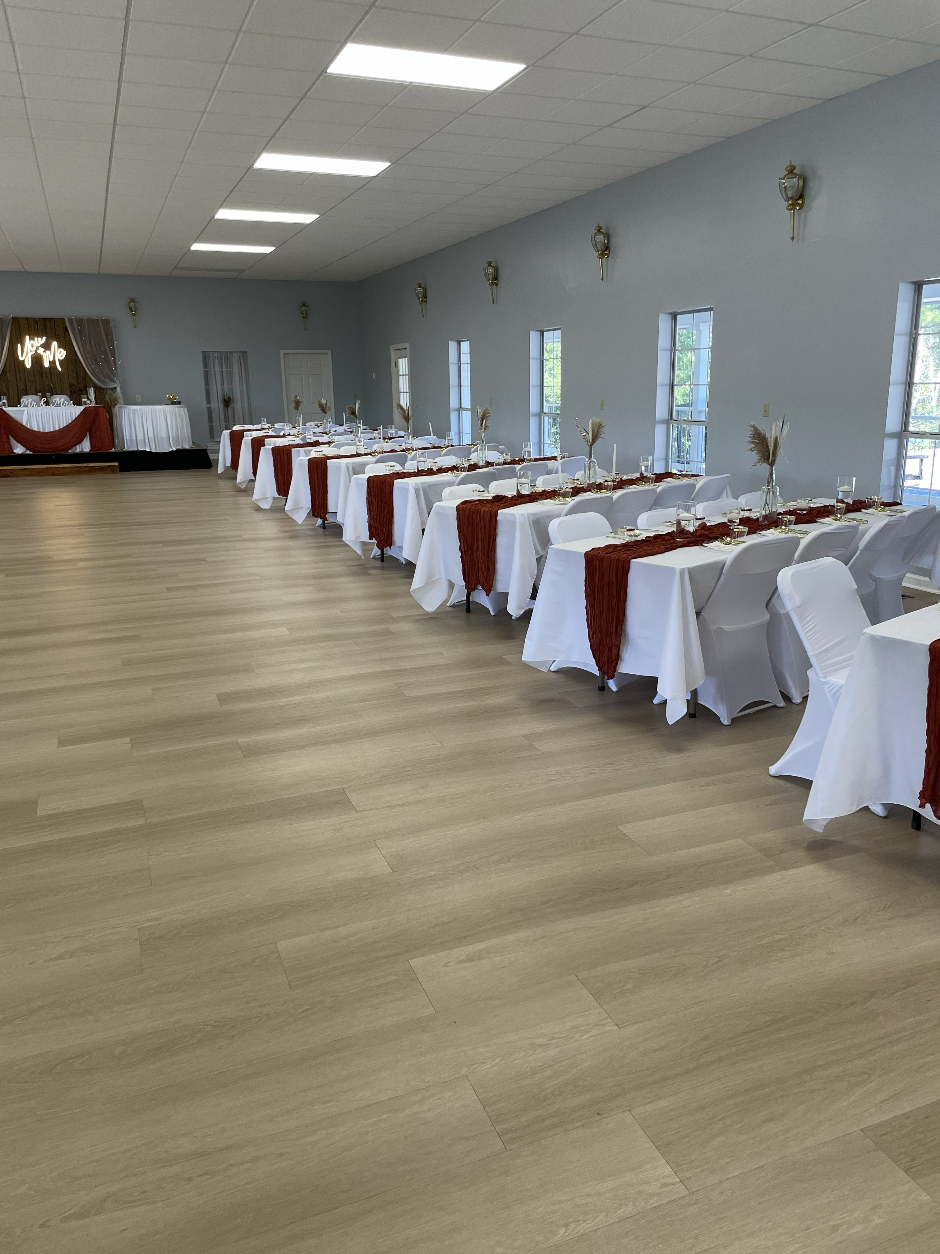 Decorated banquet tables with runners inside the Event Hall