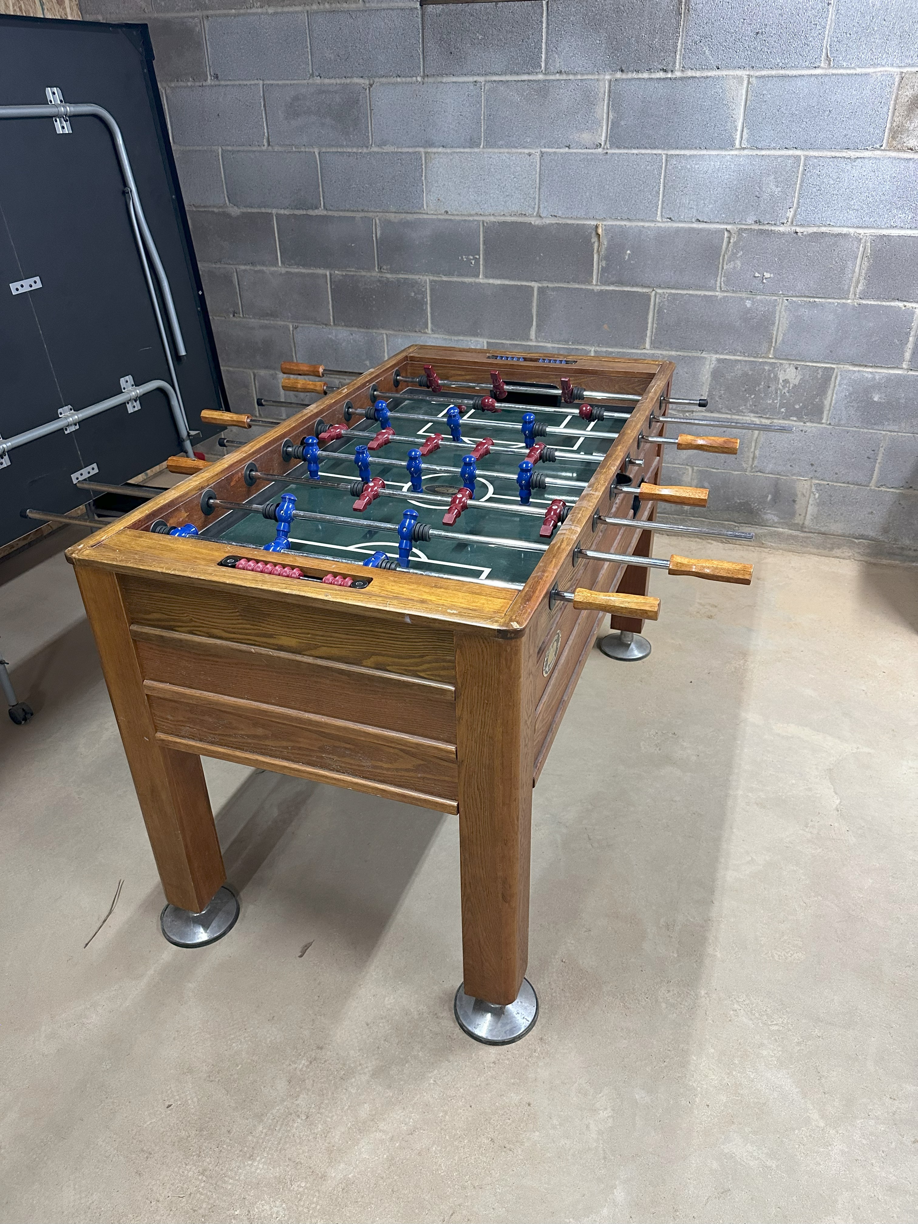 Classic wooden foosball table in game room