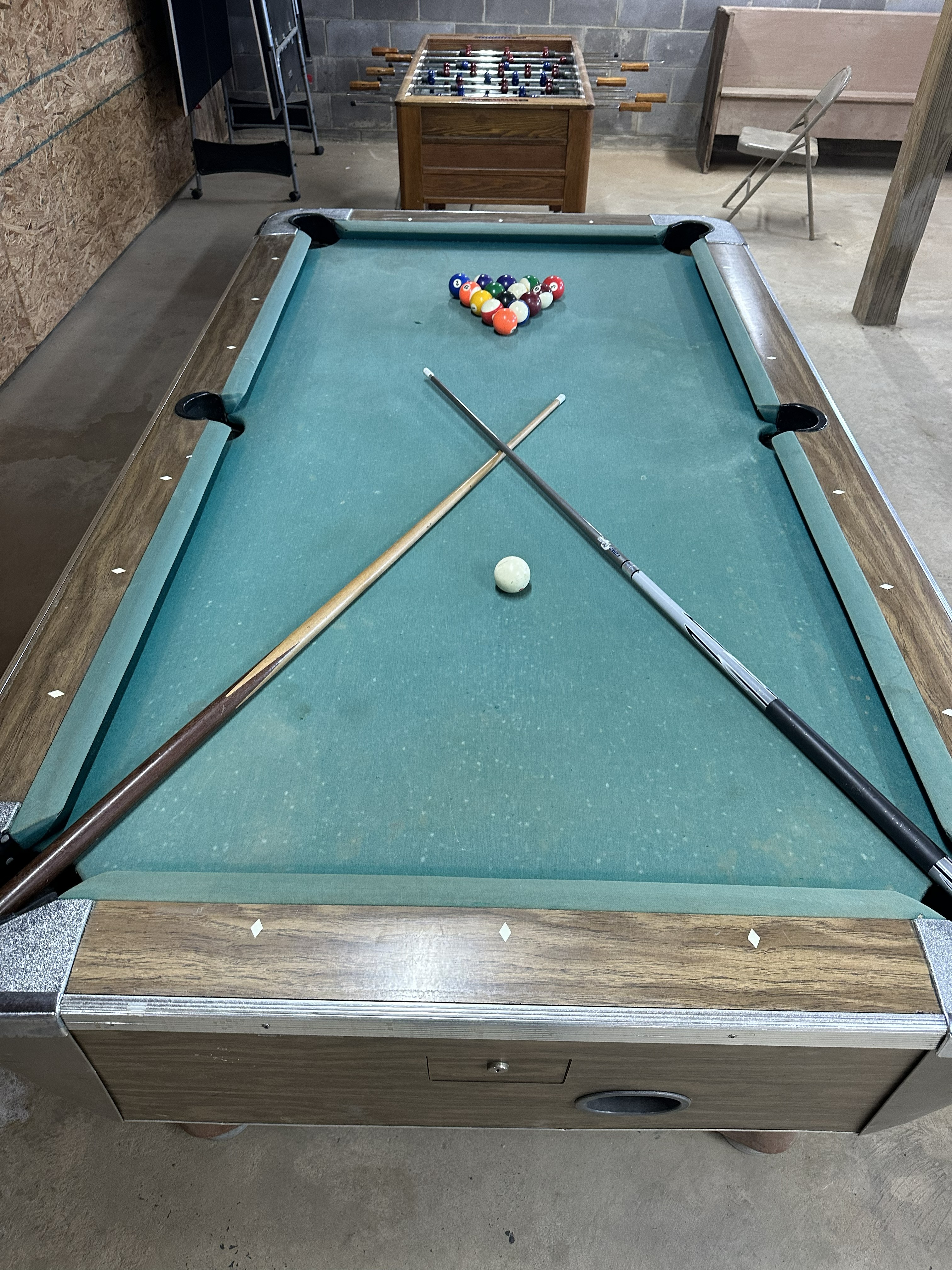 Game room pool table with cues and billiards balls
