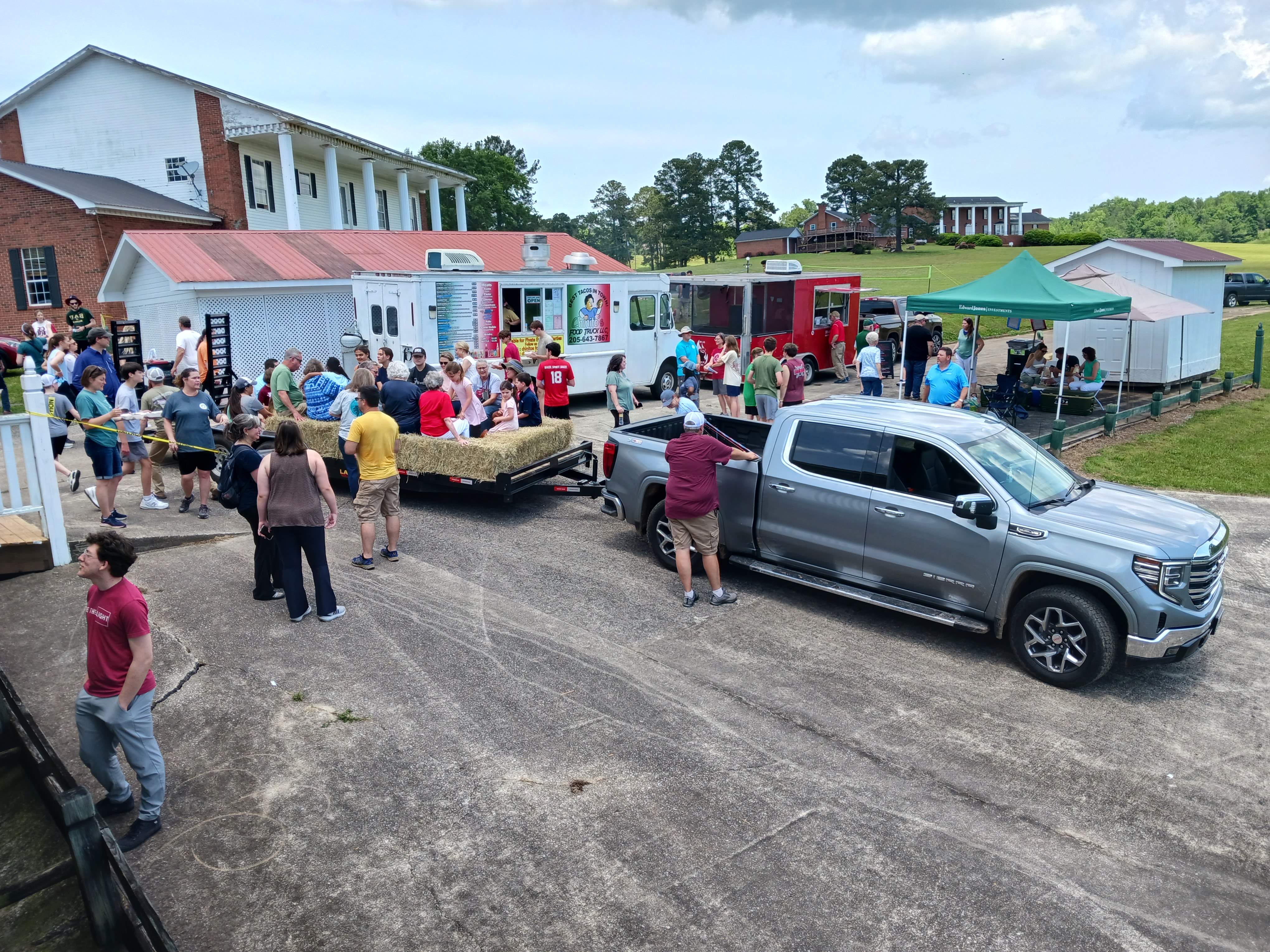 A community gathering on the lawns near the pond