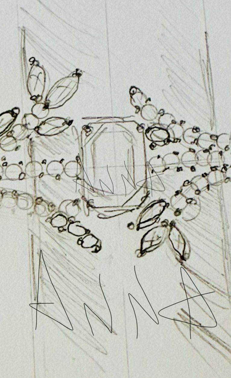 Anna sketching ring designs by hand at her workbench