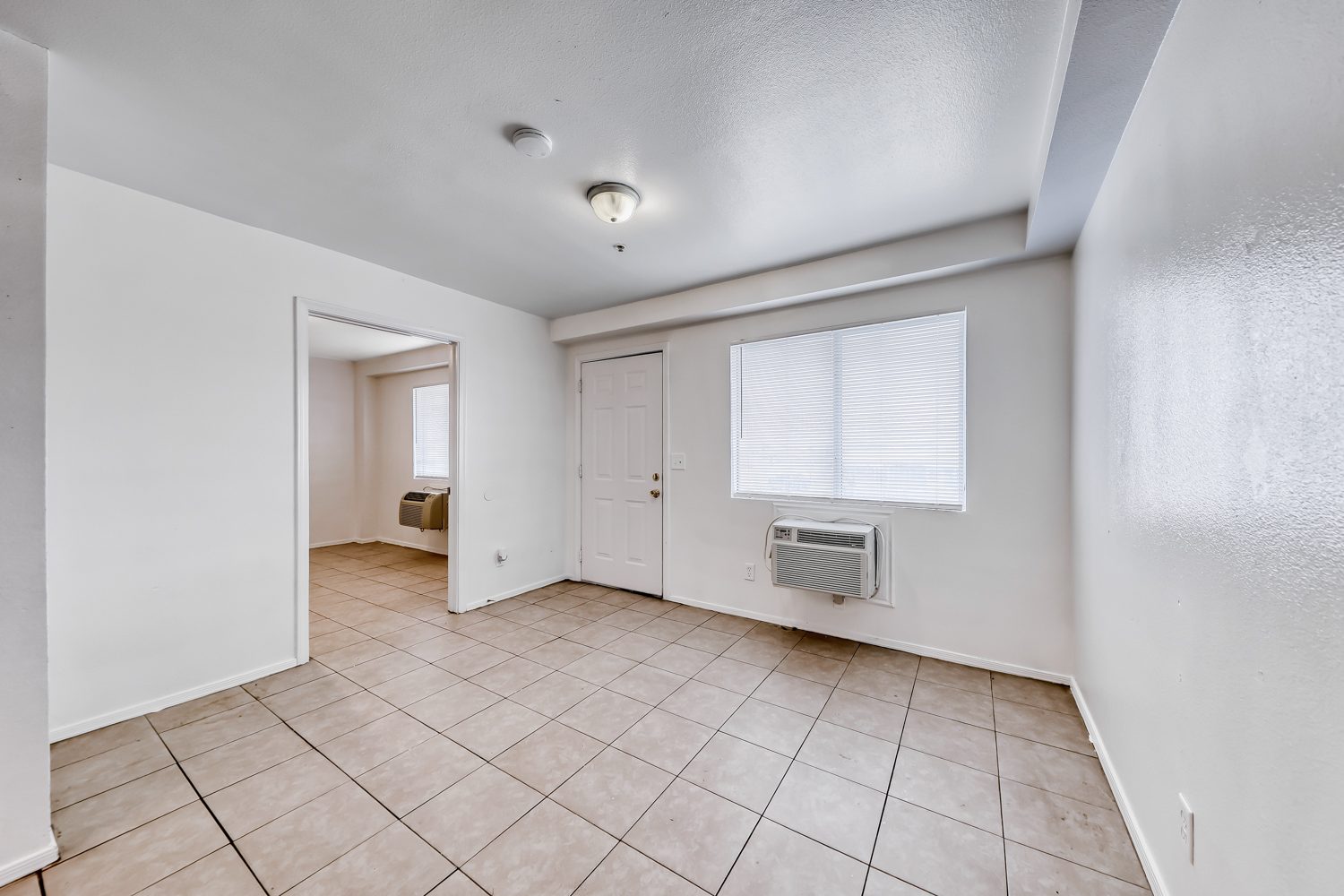 24_living_area_front_door_window_ac