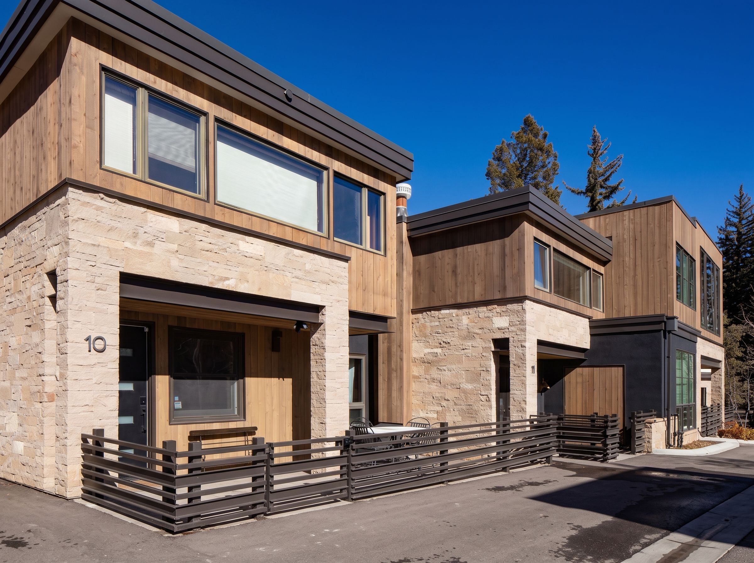 Unit 10 diagonal architectural elevation with custom perimeter metal fencing — Highlands Villas, Aspen, CO
