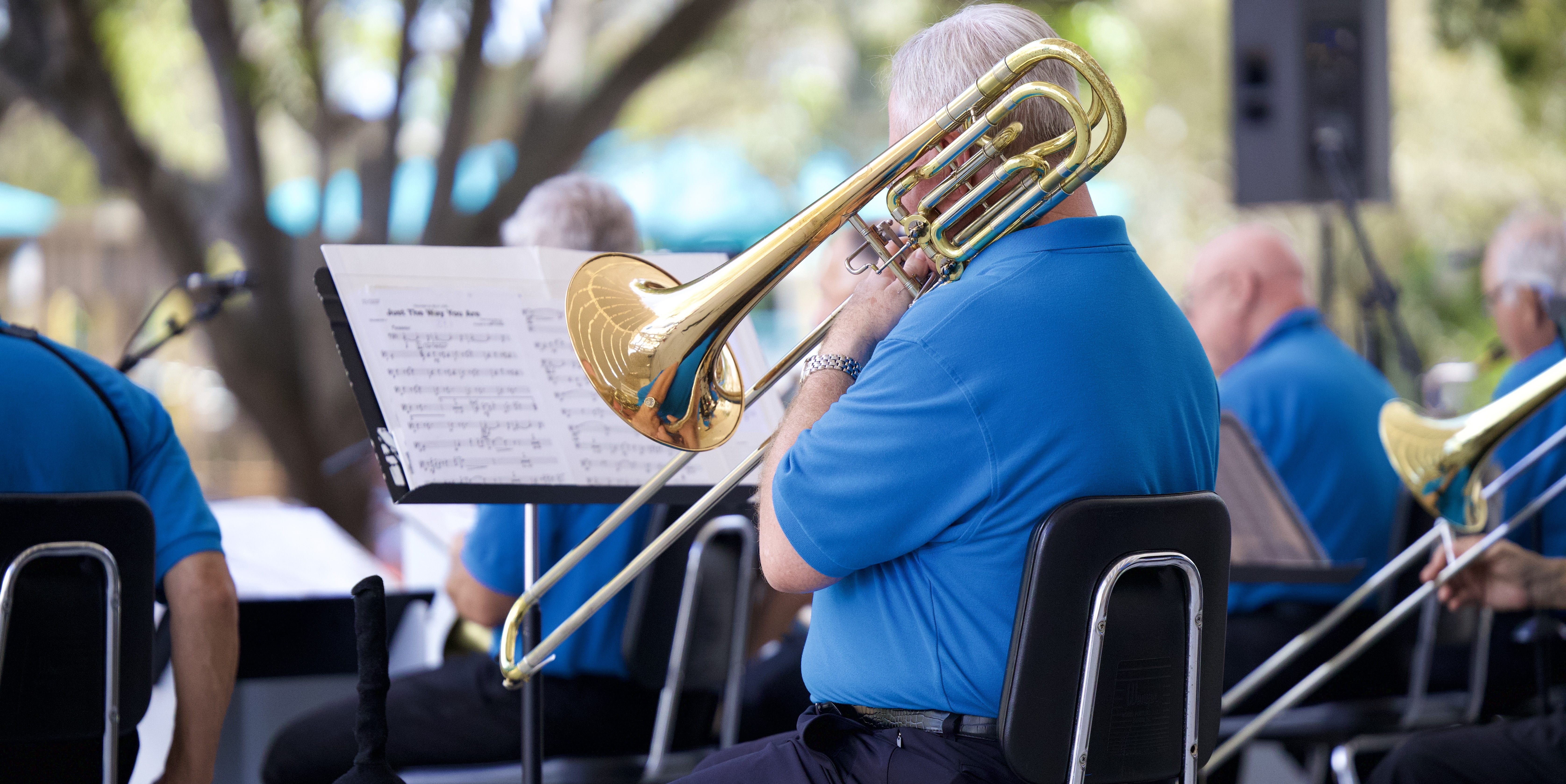 Naples Big Band trombone section performing outdoors in concert