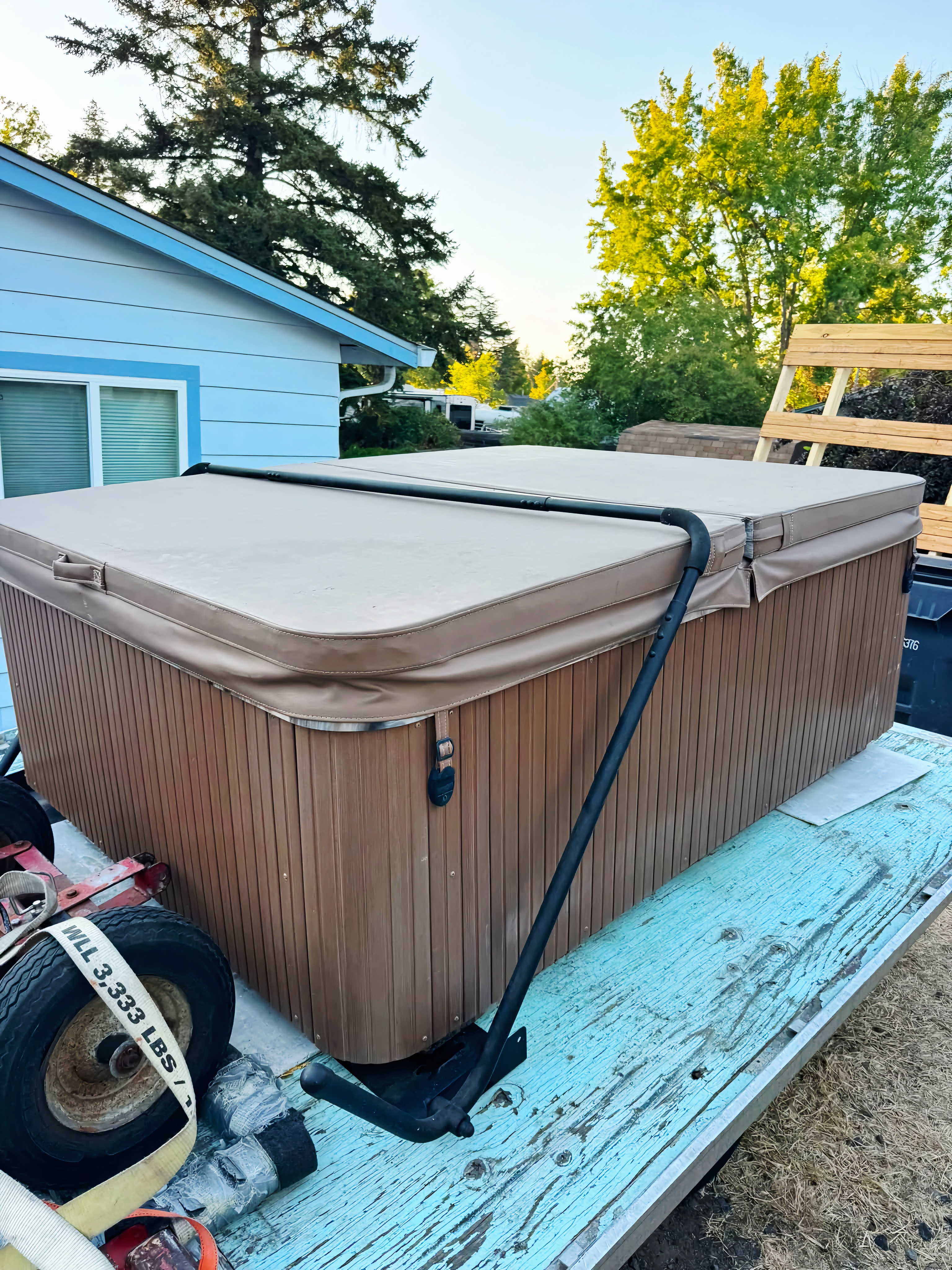 Hot tub secured on a trailer for transport.