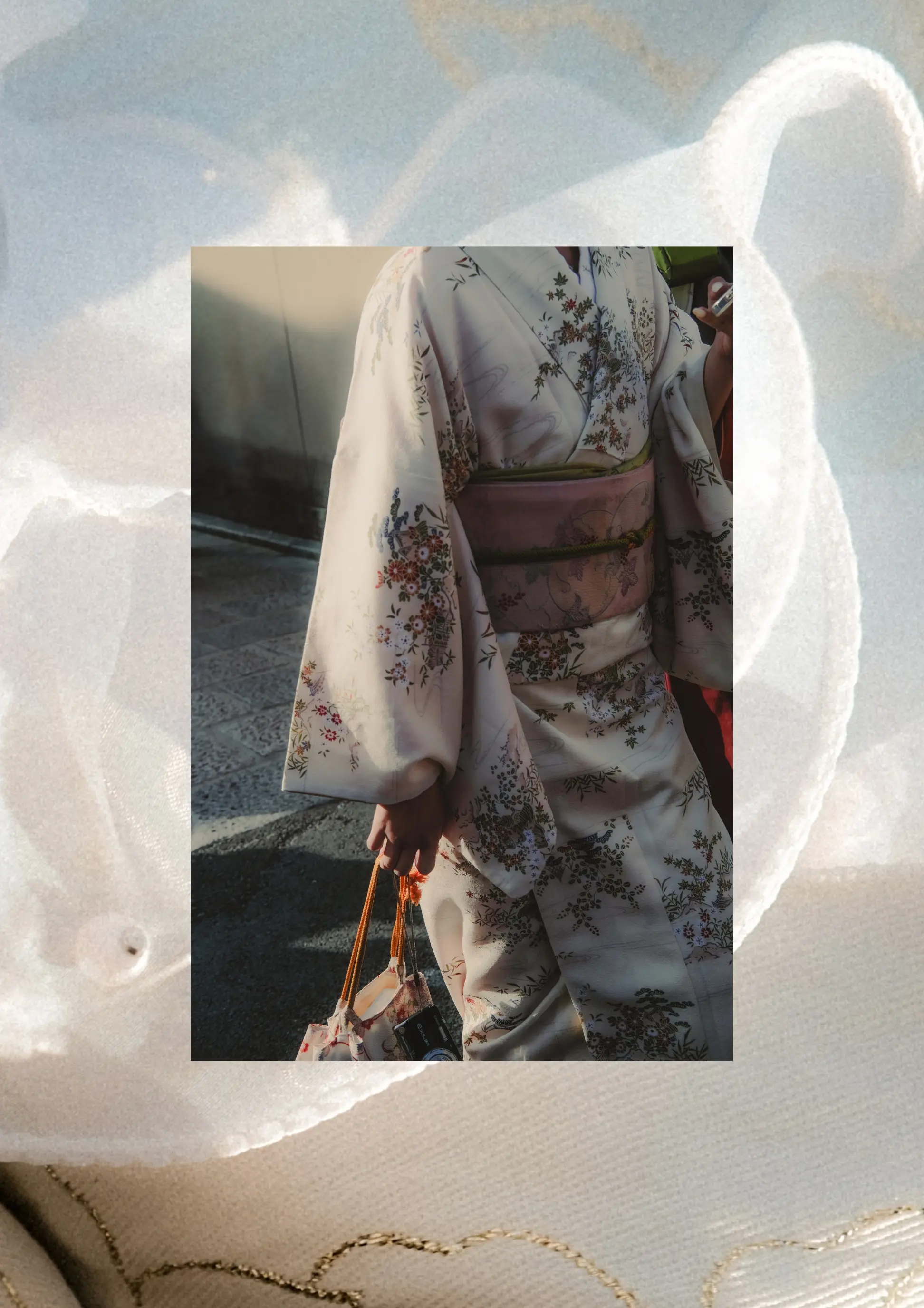 Framed portrait composition of person in embroidered floral kimono framed over soft textured fabric