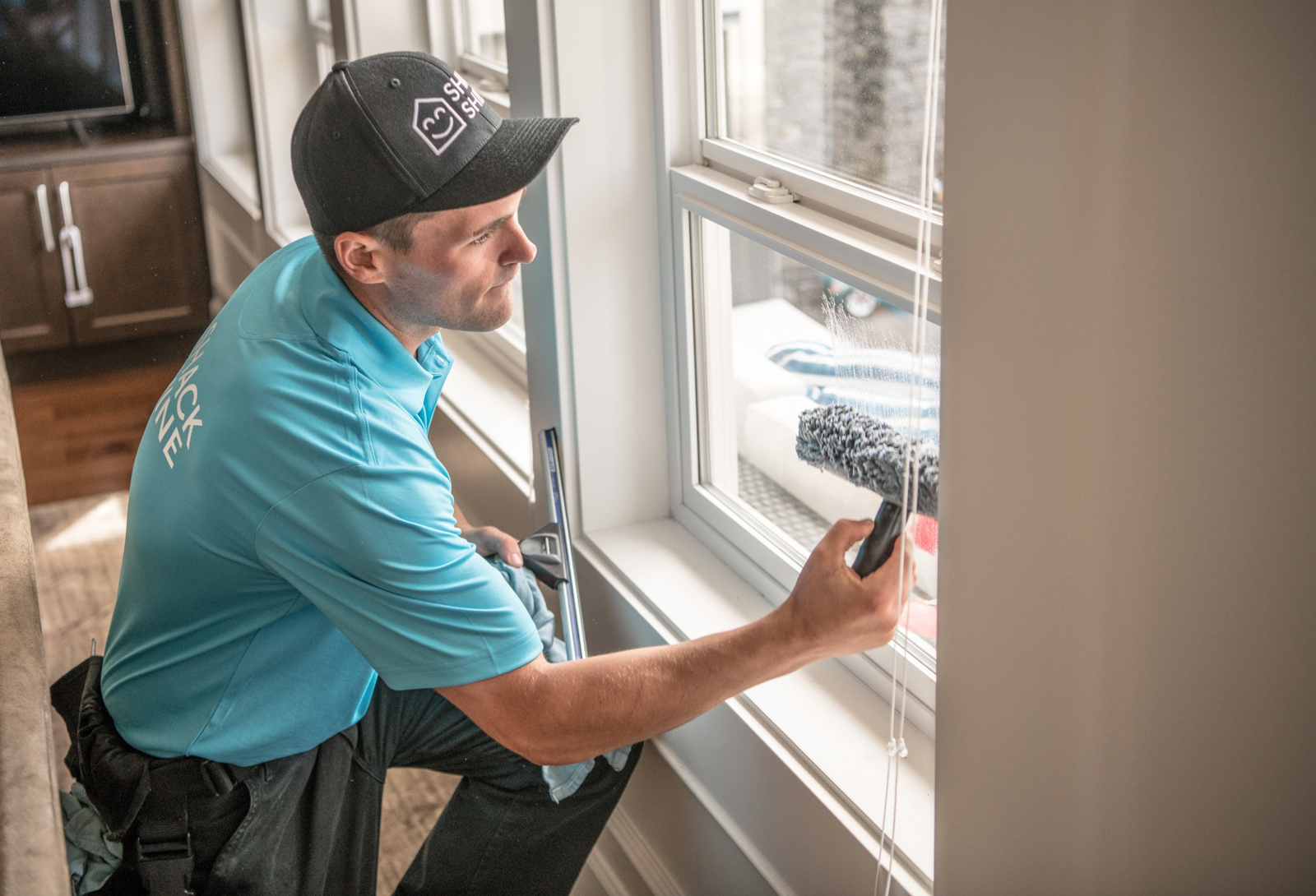 Shack Shine technician carefully detailing interior window glass with clean indoor equipment