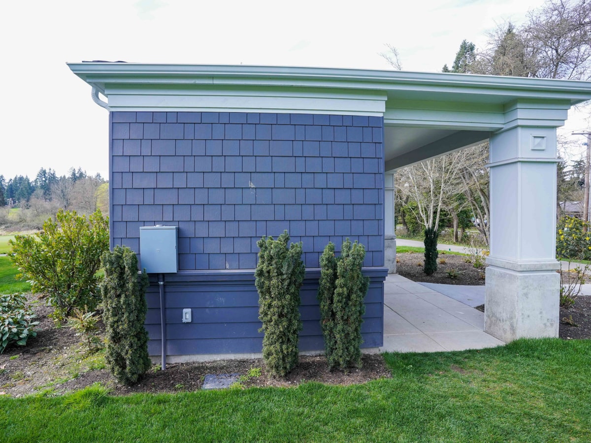 Side profile showing classical white portico column paired with Charcoal Grey siding in Medina WA