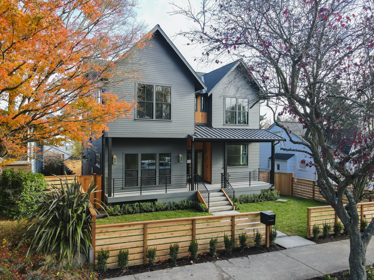 Architectural shingle roof and standing seam metal porch roof over James Hardie fiber cement siding in Seattle WA
