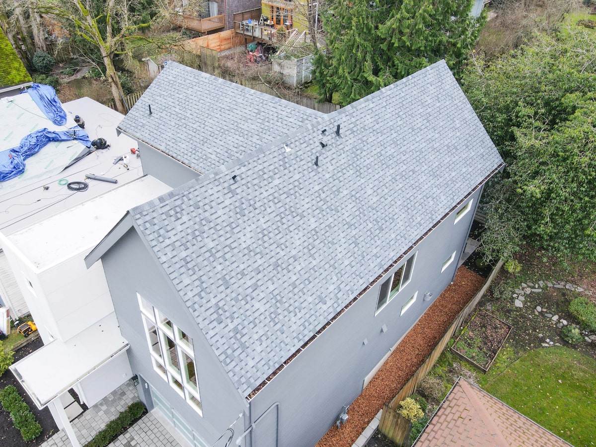 Aerial perspective of architectural shingle roof installation and side elevation with Hardie lap siding