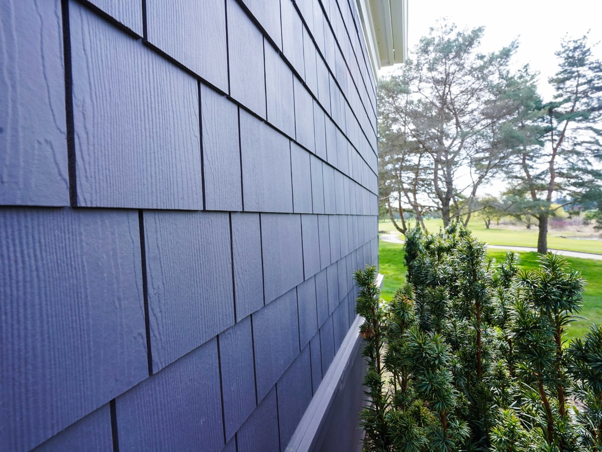 Architectural detail of Charcoal Grey fiber cement shingle siding course lines in Medina WA