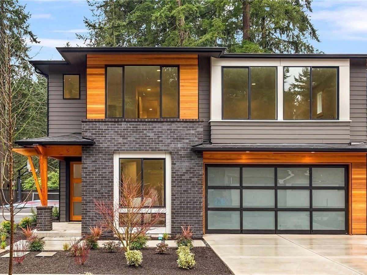 Cedar siding with brick and stone exterior at dusk on a Kirkland WA home by Best Quality