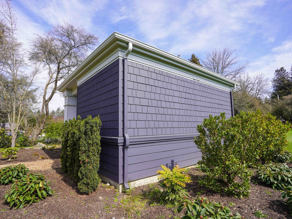Fiber cement shingle siding corner detail with gutter on a Medina WA exterior