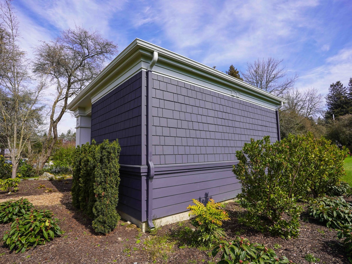 Exterior corner view with crisp white gutters and Charcoal Grey fiber cement siding in Medina WA