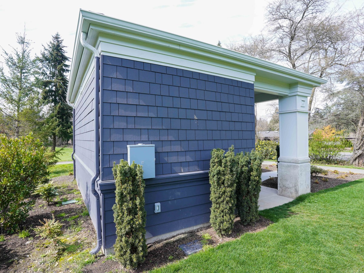 Charcoal Grey shingle siding wall with manicured shrubs in Medina WA