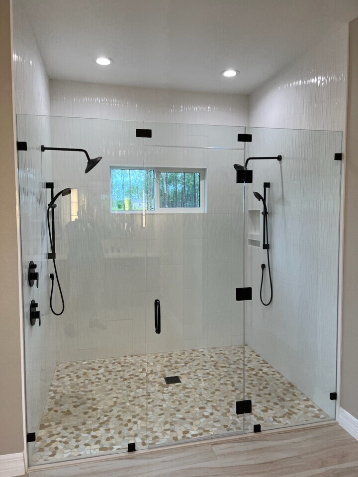 Dual Frameless Walk-In Shower with River Rock Floor & Matte Black Fixtures — Remodeling, Tampa Bay, FL