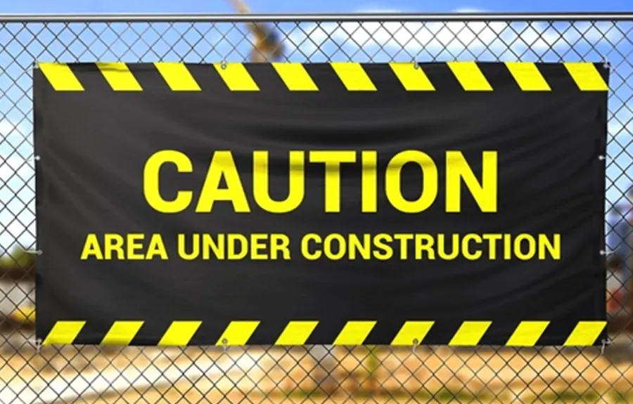 Black and yellow caution area under construction banner