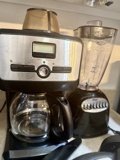 Programmable drip coffee maker with glass carafe and Oster countertop blender