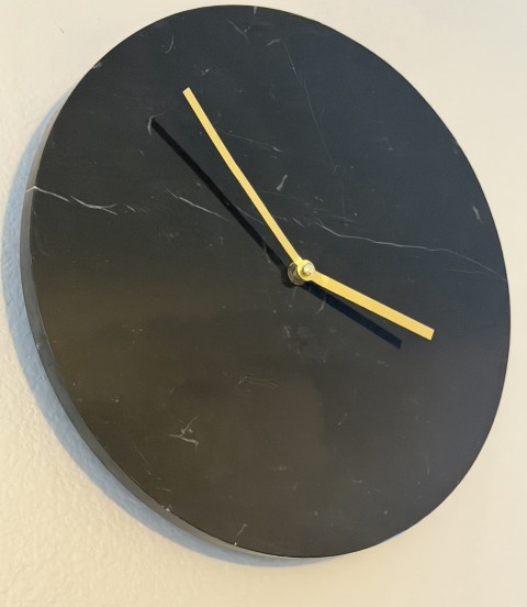Minimalist round black marble wall clock with brushed gold hands