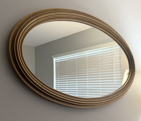 Oval decorative wall mirror with ribbed classic antique gold frame