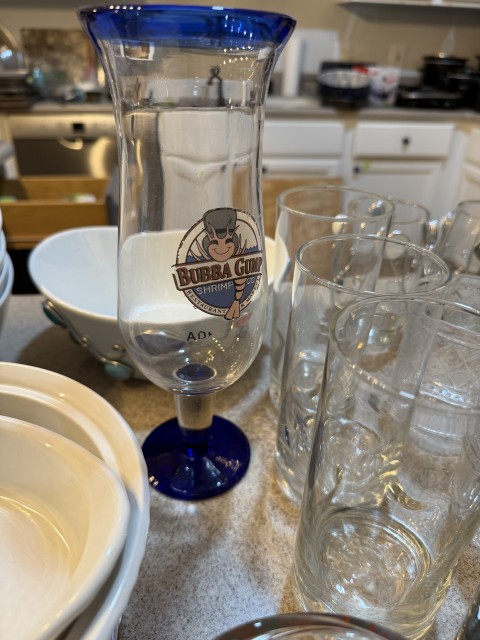 Bubba Gump Shrimp Co. tall cocktail glass with cobalt blue rim and foot