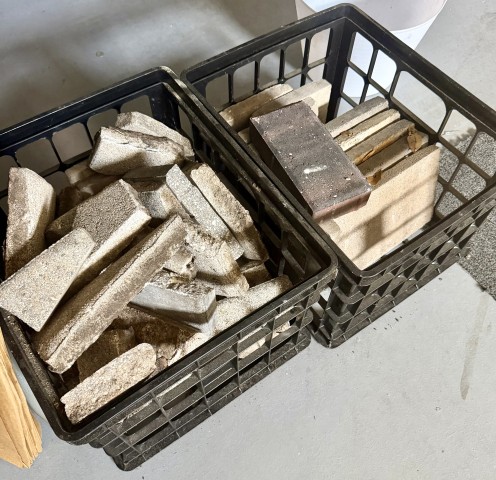 Crates of concrete patio pavers, edgers, and landscaping bricks