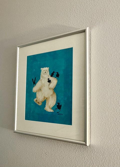 Framed whimsical polar bear with black crows artwork in silver frame