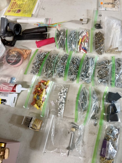 Organized hardware assortment including screws, fasteners, anchors, and wire connectors