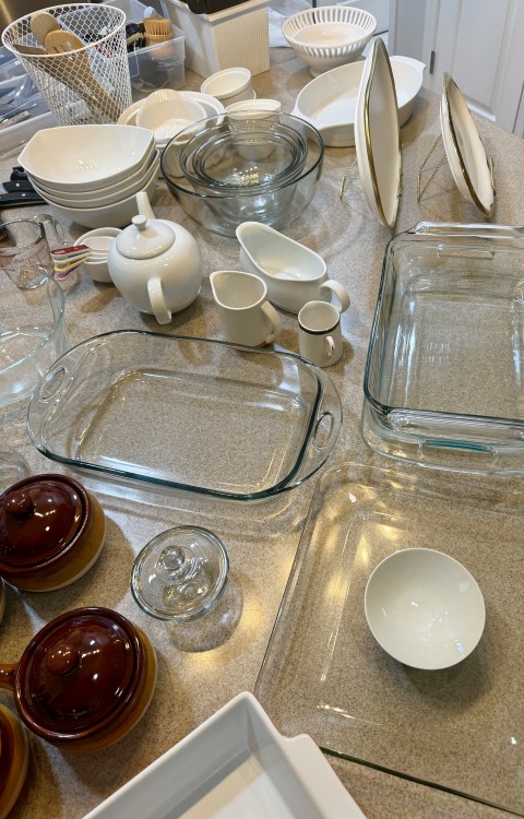 Assorted glassware, Pyrex baking dishes, ceramic teapots, and serving bowls