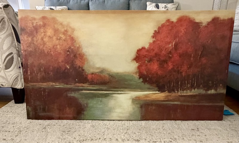 Large framed autumn landscape painting of red trees and quiet water