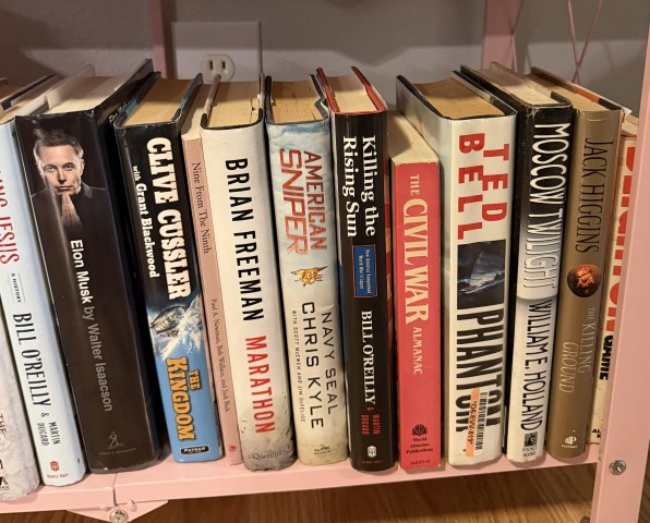 Assorted biography, history, and fiction books including Walter Isaacson and Clive Cussler