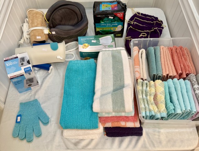 Assorted bath towels, washcloth bin organizer, blood pressure monitor, and health essentials