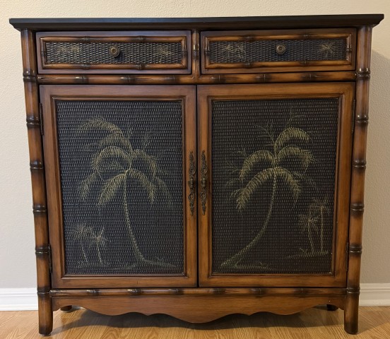 Tropical carved wood cabinet with bamboo trim and palm tree motif woven doors