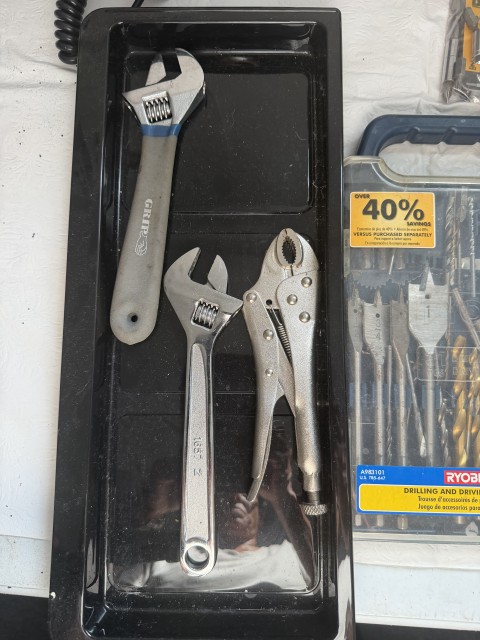 Adjustable wrenches and locking pliers hand tools in black organizer tray