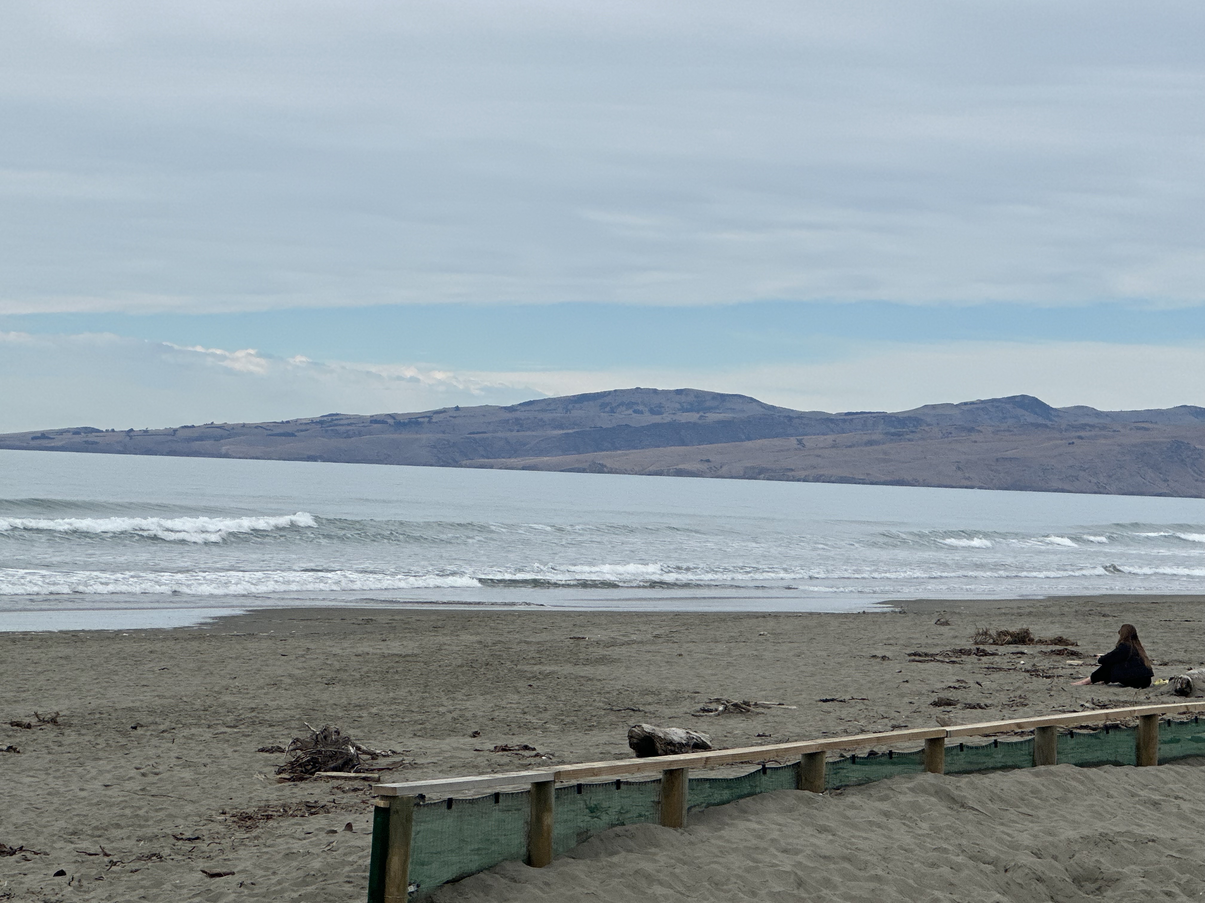North New Brighton beach with hills in the background
