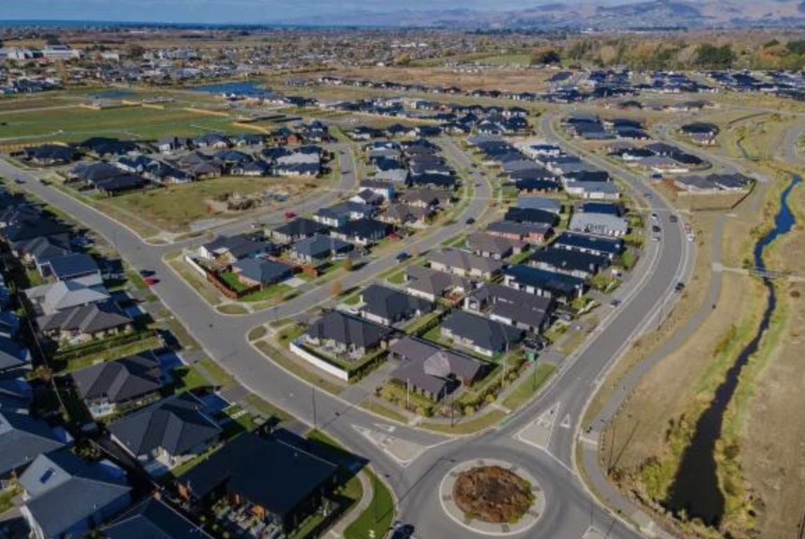 Aerial view over modern subdivisions in Marshland with open country beyond