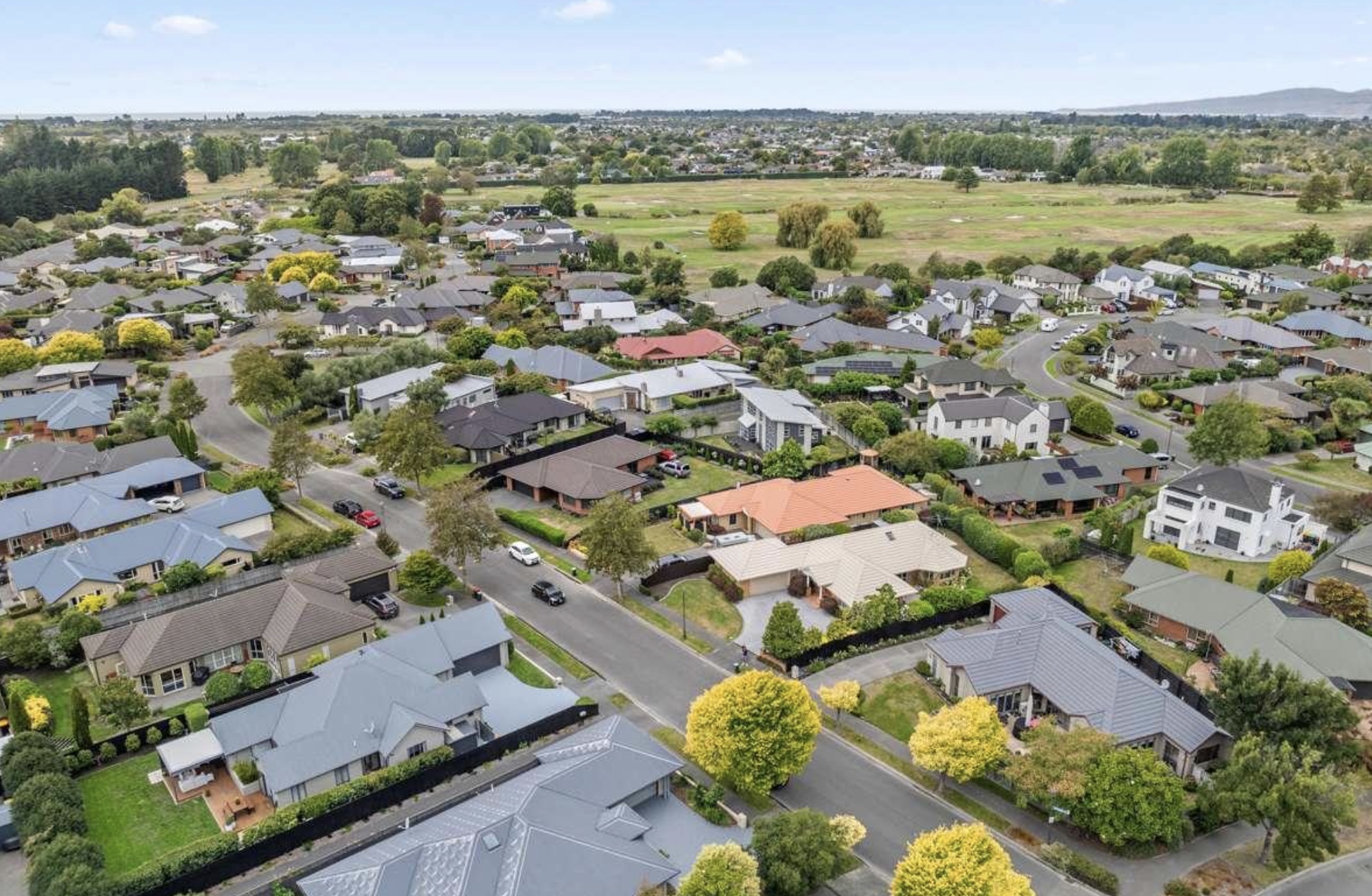 Aerial view over Shirley residential streets, golf course and open parkland